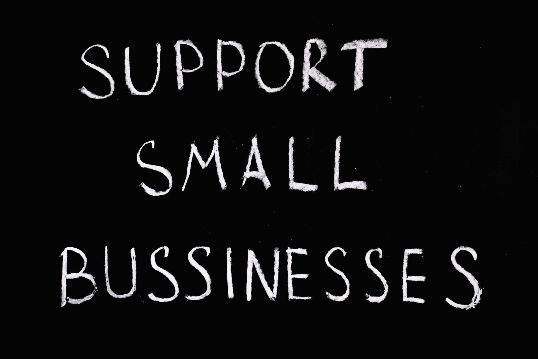 support small businesses lettering text on black background